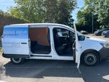 the van is parked in the parking lot with its door open