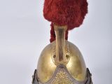 an old helmet with a red pom - pom on top of it