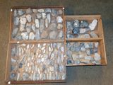 two wooden boxes filled with rocks sitting on top of a carpeted floor