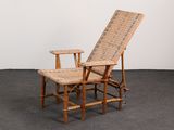 a chair and a table in a room with a white wall