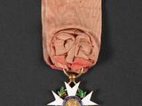an image of a medal with a star on it on a black surface