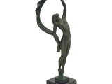 statue of a man holding a circle in his hands