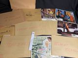 a pile of old postcards on a black surface