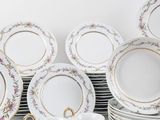a lot of plates and cups on the table