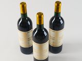 three bottles of wine sitting on top of a table next to each other