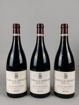 trois bouteilles de vin rouge sont alignées sur une table