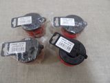 four black and red electrical wire spools with labels on them