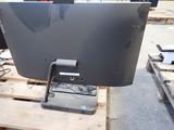 a computer monitor sitting on a pallet in a warehouse