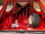 a red car that has a tire in the back of it