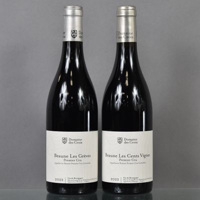 two bottles of wine sitting on top of a table next to each other