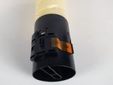 a close up of a yellow and black light bulb on a white surface