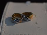 two wedding rings sitting on top of a white box