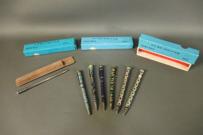five pens and a box of pencils on a table
