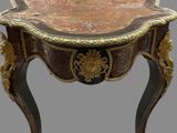 a small table with a marble top on a stand