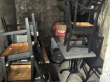 a room with a bunch of chairs and a table in it