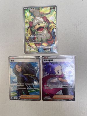 three pokemon cards are sitting on top of each other on a table