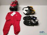 three pairs of shoes and a baby ' s footwear laid out on a table