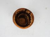 a brown bowl sitting on top of a white table