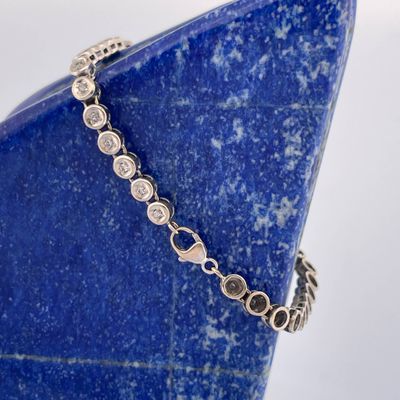 a close up of a bracelet on a blue stone