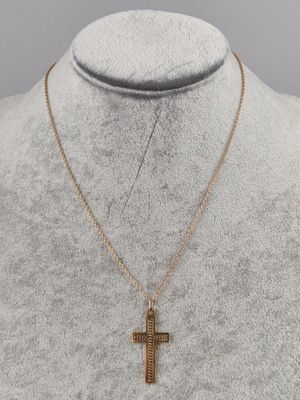 a gold cross necklace on a mannequin mannequin mannequin mannequin mannequin mannequin mannequin mannequin manne