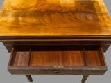 an old wooden table with two drawers and a drawer underneath it