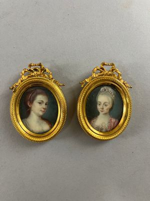 two miniature portraits of women in gold frames