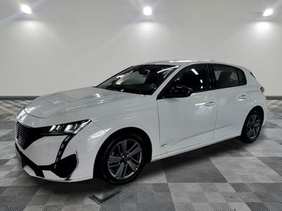 the white car is parked on a checkered floor in the garage