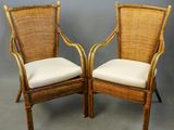 pair of vintage rattan chairs with white cushions