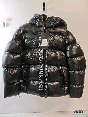 the jacket is hanging on a hanger on the wall