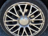 a close up of a car ' s tire on the pavement