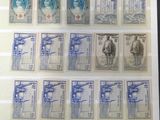 an old picture of a collection of stamps on display in a glass case