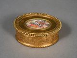 a gold box with a picture on it on a table