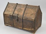 an old wooden chest sitting on top of a white surface