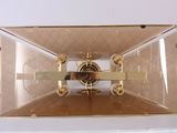 a clear box with a clock inside of it on a table