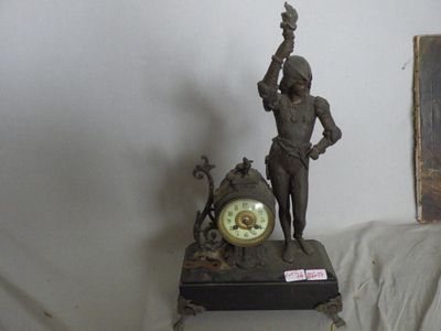 a statue of a man holding a clock on a table