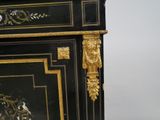 a black and gold cabinet with a clock on top of it