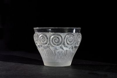 a glass cup that is sitting on a table