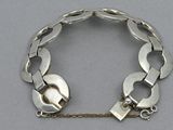 silver bracelet with links and padlocks on a chain