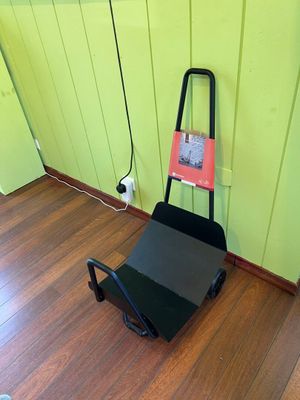 a black cart with a book on it in a room