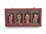 three wooden statues of buddhas in a display case