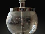 a glass vase with a candle inside of it on a table