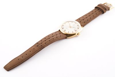 an image of a watch with a brown leather strap on a white background