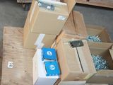 many boxes of screws and screws sitting on a pallet