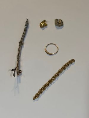 a white table with a bunch of jewelry on it