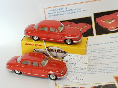 a red toy car sitting on top of a yellow box
