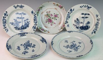 six blue and white plates with floral designs on them sitting on a table