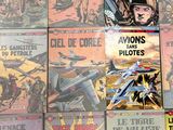 a lot of comic books on the table together