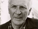 black and white photograph of a man with a plaid shirt and jacket