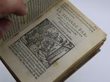 someone is holding a book with a picture of a man on it