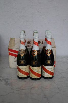 four bottles of champagne are lined up on a counter top
